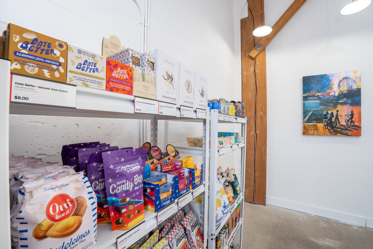 Gourmet pantry shelves with a painting on the wall beyond